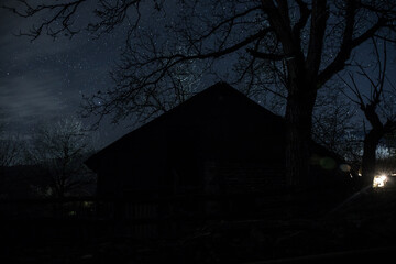 Wall Mural - old house with a ghost in the forest at misty night or night scene with house under moon. old mystic