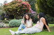 © Dani Nahuel/Stocksy - Two Latin Brunette Women Friends Sitting on the Grass