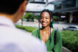 © Jovo Jovanovic/Stocksy - Smiling female and male coworkers discussing outdoors