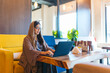 © Daniel Gonzalez/Stocksy - Young emirati businesswoman working on laptop in modern cafe