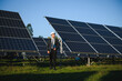 © Serhii - Businessman or engineer standing near solar panels