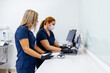 © VICTOR TORRES/Stocksy - Healthcare professionals using laptops in a clinical setting