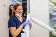 © VICTOR TORRES/Stocksy - Healthcare professionals smiling in a modern dental clinic