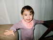 © Ezequiel Giménez/Stocksy - UGC Baby girl standing and smiling at home