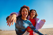 © Javier Díez/Stocksy - Cheerful black women taking selfie on beach
