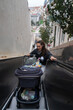 © Raul Navarro/Stocksy - Mother transporting baby stroller on escalator in urban setting