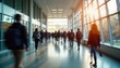 © Pete - Many students walk in a university hallway. Sunny day. Busy campus. People are focused on their journey. Lots of motion. Back to school atmosphere. Indoor setting. Modern campus style.