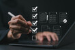 © Goodtime - Digital form checklist, Online survey concept. Women interacts with digital form checklist on laptop with process of filling out online survey and completing digital forms with checkbox and document.