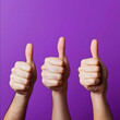© estrel - three thumbs up on a vivid bright purple background view from aside