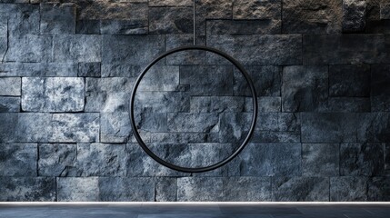 Poster - A hanging circle suspended in a minimalist design, set against a rugged stone background, creating a harmonious balance of simplicity and texture