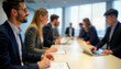 © Pete - Business people seated at meeting table. Attendees registering participating in business event. Blurred background shows office setting. Pro atmosphere. Conference seminar in progress. Corporate