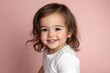 © andyaziz6 - Adorable Toddler Smiles Brightly Against Pink Background, Captivating Childhood Innocence, Joyful Expression, Happy Child Portrait, Sweet Girl Photo,  Positive Emotions.