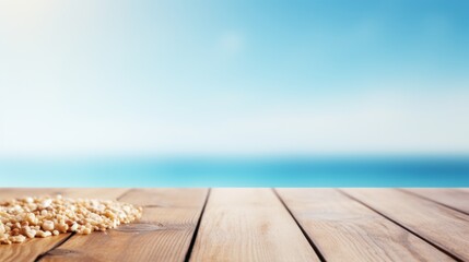 Wooden tabletop with smooth grains and a natural finish, with soft bokeh effects of sparkling sea water and a clear blue summer sky in the background,