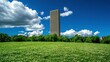 © ACE STEEL D - Modern Skyscraper Towering Over Lush Green Meadow in City Park on Sunny Day
