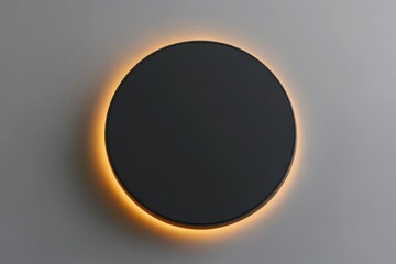 Poster - illuminated black circle on gray wall.