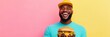 © Ryzhkov - Joyful Street Food Delight Man Enjoying a Giant Cheesy Burger Against Vibrant Pastel Background