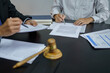 © Charlie's - Legal counsel presents to the client a signed contract with gavel and legal law. justice and lawyer concept