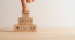 © Parradee - Empathy concept. Wooden blocks with empathy icons on minimal background and copy space. The power of emotional intelligent, soft skill development. Empathy in the workplace, good leaders, good teams.