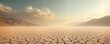 © Pete - Dried lakebed panorama shows cracked earth surface. Dusty sky stretches over arid landscape. Mountains surround dry terrain. Climate change causes desert expansion. Resource depletion evident.