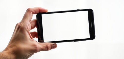 Aufkleber - Hand holds black smartphone horizontally. Phone screen displays blank white space, suitable for advertisement video app. Image taken against plain white background. Blank screen phone mockup perfect