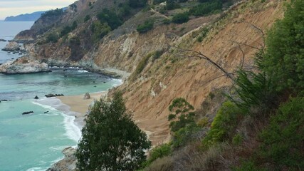 Wall Mural - Aerial view of McWay Falls on the Pacific coast along Highway 1 in California. Big Sur, Lucia. Travel concept, tourism, journey, vacation. 4K video.