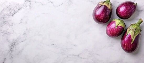 Poster - fresh eggplants arranged on a white marble background showcasing minimalism and healthy eating with 