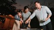 © Summit Art Creations - Family celebrate holiday in garden. Father, mother and child grill food for member. Outdoor camping activity to relax with meal and spend time with young generation cross generation gap. Divergence.