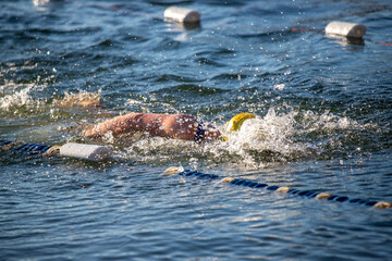 Wall Mural - A swimmer is in the water, splashing and swimming