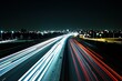 © Resni AI - Night highway traffic light trails with city skyline in background.
