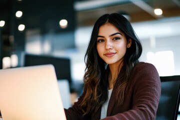30s young business woman working on laptop pc sitting at desk in modern office, focused professional