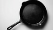 © Sirichat. Camphol - A cast iron skillet with a smooth black surface, isolated on white
