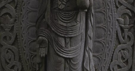 Wall Mural - A religious stone statue of Kannon at Japanese buddhism temple