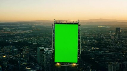Poster - Modern city skyline with digital billboard shining in sunset light