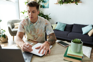 Young man with prosthetic leg creatively working at home in a vibrant living space