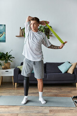 Wall Mural - Young man with prosthetic leg practices stretching with resistance band indoors