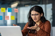 © Liubomir - Upset and disappointed woman working in the middle of the office with a laptop close up. Businesswoman on a work month looking dissatisfiedly at the laptop screen, working at the workplace.
