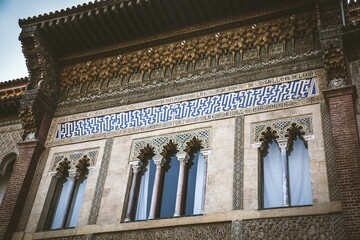 Wall Mural - Mudejar facade and inscription of the Palace of Pedro I in the Royal Alcazars of Seville.