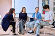 © Valerii Honcharuk - Group of teenage students with female teacher counselor inside classroom library