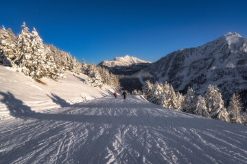 Imagine being in a stunning winter landscape with fluffy snow blanket, towering mountains and clear blue skies, ideal setting for thrilling skiing and snowboarding adventures, Montgenevre, Alps France