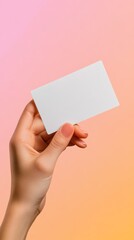 Poster - Hand with varnished nails holding a levitating blank business card on a colorful gradient background, perfect for showcasing your design or message