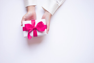 Wall Mural - celebration,special day and valentine's day with young person hand giving chic gift box