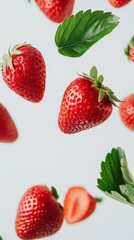 Aufkleber - Ripe red strawberries and lush green leaves floating gracefully in mid air against a pristine white backdrop, creating a striking and lively visual composition