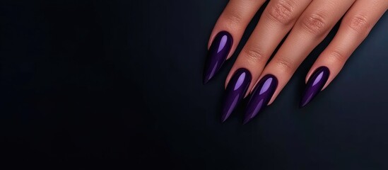 Poster - elegant woman's hand displaying long, pointed violet purple nails on a dark background with ample em