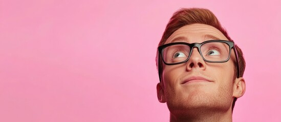 Poster - caucasian man in eyeglasses pondering with upward gaze against vibrant pink background showcasing am