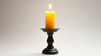 Poster - Elegant black candlestick holding a lit yellow candle on a neutral background creating a warm and inviting ambiance.