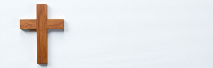 Aufkleber - A Brown Wooden Cross Is Placed On A White Textured Background With Simplicity And Elegance In Its Design. 00001