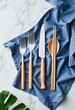 © LTh - Forks knife spoon and chopsticks on blue cloth with green leaf
