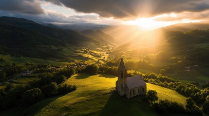 Poster - A dramatic sunrise casting light on an ancient stone church in a rural valley