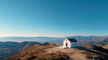 Poster - A peaceful mountaintop scene with a small white chapel under a clear blue sky