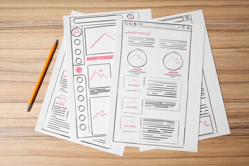 Leinwandbilder - Website development. Sketches of wireframes and pencil on wooden table, flat lay